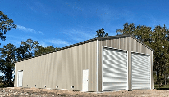 25x55 steel building with roll-up doors, custom siding, and clear-span interior.
